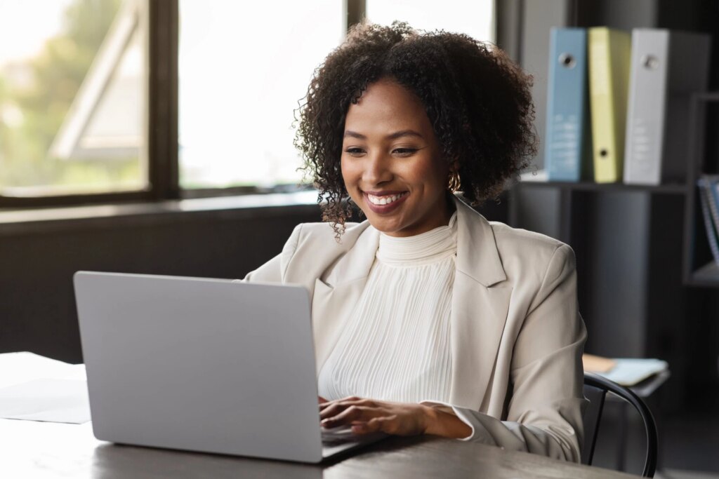 Cheerful middle-aged real estate agent working on laptop social strategy